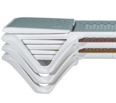 Several sun loungers are shown stacked on a bollard