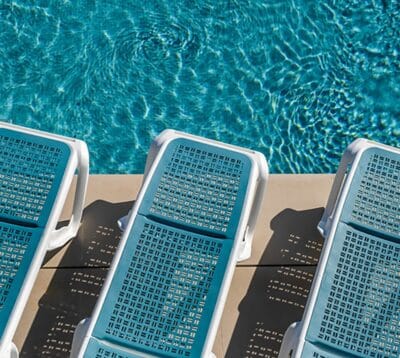 3 sun loungers with white frame and sky blue backrest are shown.