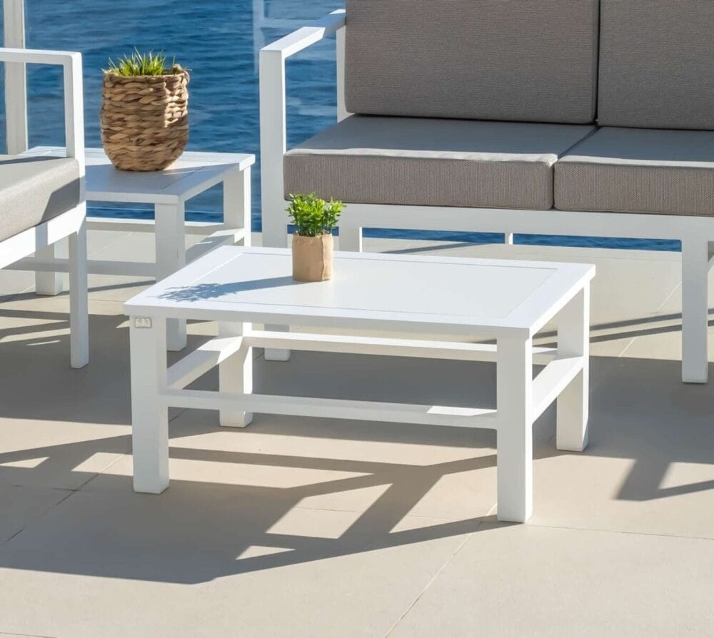 Minimalist white coffee table - Olimpia central model, offering a contemporary and functional design, perfect for modern living rooms or reception areas. It can be seen together with two sofas creating a set.