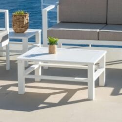 Minimalist white coffee table - Olimpia central model, offering a contemporary and functional design, perfect for modern living rooms or reception areas. It can be seen together with two sofas creating a set.