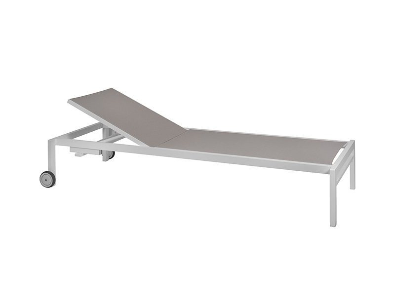 The image shows an adjustable sun lounger with wheels dove-colored fabric and a aluminum frame. The sun lounger has a raised headrest, suggesting it can be adjusted for comfort. Two small wheels are attached to one end of the frame, indicating that the sun lounger can be easily moved.